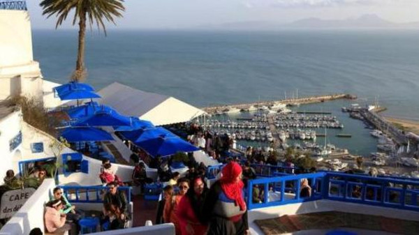 Tourists are seen in a coffee shop in Sidi Bou Said, a tourist destination, on the outskirts of the capital Tunis