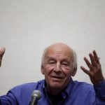 Uruguayan writer Eduardo Galeano gestures while addressing the audience at the municipal palace in Mexico City