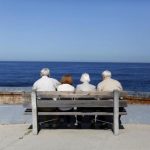 Elderly couples view the ocean and waves along the beach in La Jolla
