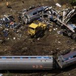 Emergency workers and Amtrak personnel inspect a derailed Amtrak train in Philadelphia, Pennsylvania