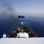 A group of 300 sub-Saharan Africans sit on board the Italian Finance Police vessel Di Bartolo as their boat is left to adrift off the coast of Sicily