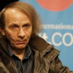 French author Houellebecq sits on stage of the Schauspiel Koeln, the public theater of the western German city of Cologne