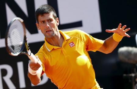 Djokovic of Serbia returns the ball to Almagro of Spain during their match at the Rome Open tennis tournament in Rome