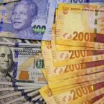Photo illustration of South African bank notes displayed next to the American dollar notes in Johannesburg