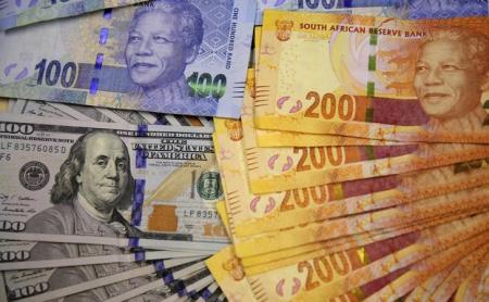 Photo illustration of South African bank notes displayed next to the American dollar notes in Johannesburg