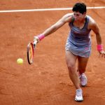 Carla Suarez Navarro of Spain plays a shot to Monica Niculescu of Romania during their women's singles match at the French Open tennis tournament at the Roland Garros stadium in Paris