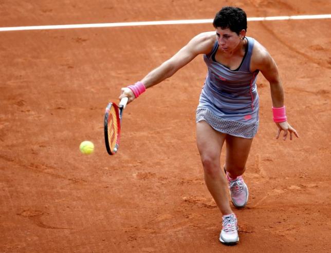 Carla Suarez Navarro of Spain plays a shot to Monica Niculescu of Romania during their women's singles match at the French Open tennis tournament at the Roland Garros stadium in Paris