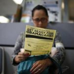 Murillo reads a leaflet at a health insurance enrollment event in Cudahy, California