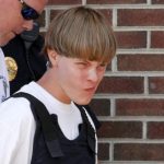 Police lead suspected shooter Dylann Roof into the courthouse in Shelby, North Carolina