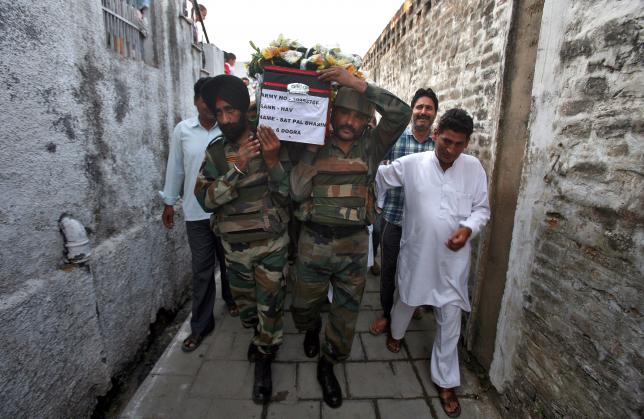 Indian army soldiers carry a coffin containing the body of their colleague Sat Pal Bhasin during his funeral on the outskirts of Jammu