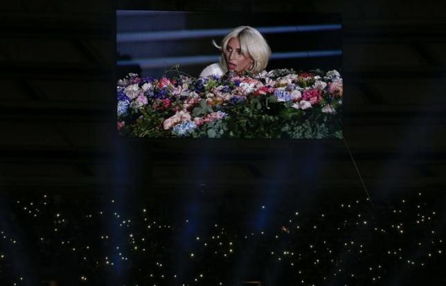 Singer Lady Gaga is displayed on a videowall while fans light their phones during the opening ceremony of the 1st European Games in Baku