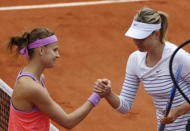 Lucie Safarova of the Czech Republic shakes hands with Maria Sharapova of Russia after winning their women's singles match during the French Open tennis tournament at the Roland Garros stadium in Paris