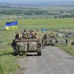 Members of the Ukrainian armed forces gather on the roadside near the village of Vidrodzhennya
