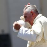 Pope Francis changes skull cap during Wednesday general audience in Saint Peter's square at the Vatican