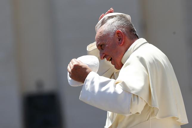 Pope Francis changes skull cap during Wednesday general audience in Saint Peter's square at the Vatican