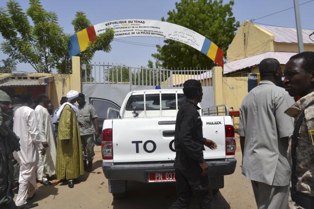 Security officers stand at the site of a suicide bombing in Ndjamena