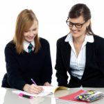 Tutor Assisting The Student In Homework