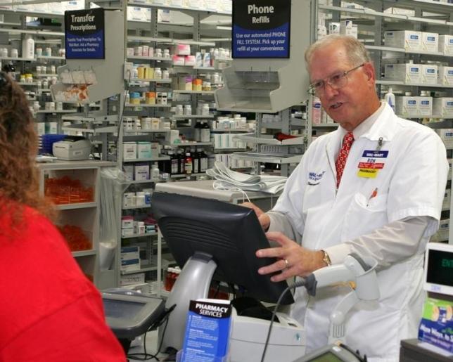 Pharmacy Manager at a Tampa, Florida Wal-Mart, completes a transaction with a customer