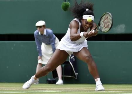 Serena Williams of the U.S.A. hits a shot during her match against Venus Williams of the U.S.A. at the Wimbledon Tennis Championships in London