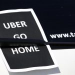 A leaflet which reads "Uber go home" is seen on a taxi as striking French taxi drivers block the traffic on the Paris ring road during a national protest against car-sharing service Uber, in Paris