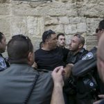 Israeli border police officers detain a Palestinian protester in Jerusalem's Old City