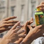 Migrants receive a juice donation