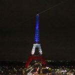 The Eiffel Tower is illuminated in the French national colors red, white and blue