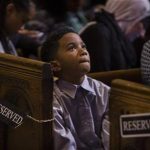 A child listens to a speech