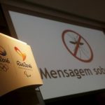 Logos of the Rio 2016 Olympic Games and Rio 2016 Paralympic Games are pictured next to a message on a screen that reads "Message about Zika" during a media briefing in Rio de Janeiro