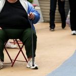 An overweight woman sits on a chair in Times Square in New York