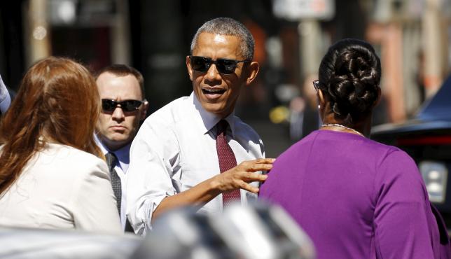 U.S. President Barack Obama arrives at a restaurant to meet with formerly incarcerated individuals who have previously received commutations from his and previous administrations in Washington
