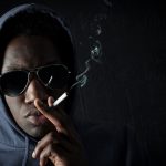 Scary black man smoking a cigarette