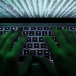 Illustration file picture shows a man typing on a computer keyboard in Warsaw