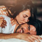 Woman kissing her boyfriend good night.