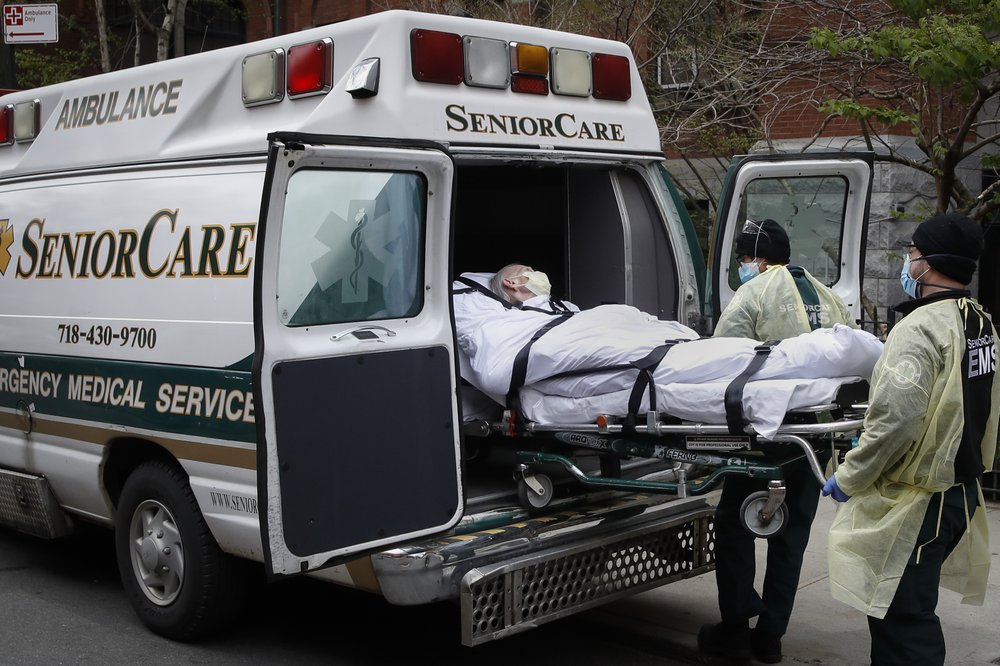 a patient is loaded into an ambulance by emergency medical workers outside Cobble Hill Health Center