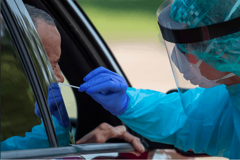 A healthcare worker uses a swab to test a man at a coronavirus disease (COVID-19)