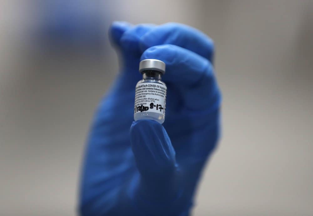 A nurse holds a phial of the Pfizer-BioNTech COVID-19 vaccine