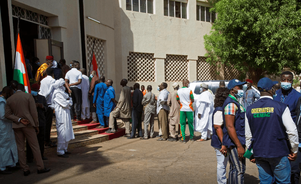 Voters queue at a polling station during the second round of the country's presidential election, in Niamey