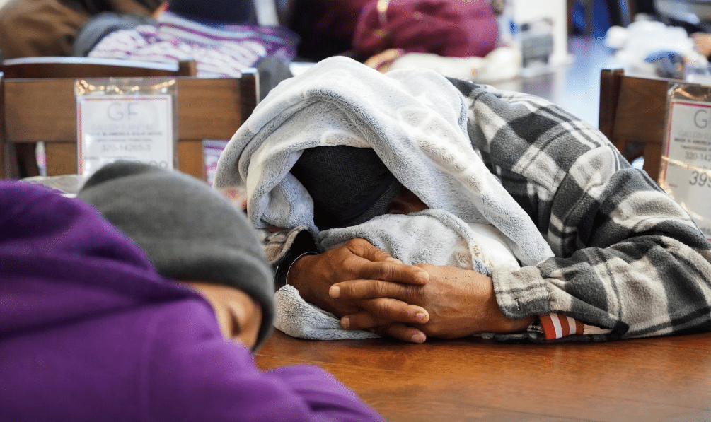 People take shelter at Gallery Furniture store which opened its door and transformed into a warming station after winter weather caused electricity blackouts in Houston