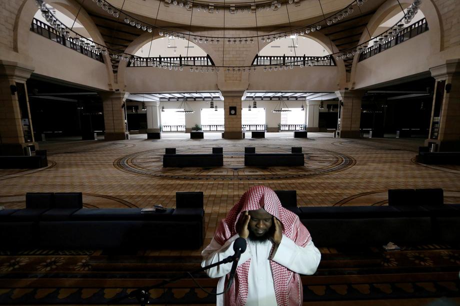 A cleric calls for the prayer at an empty Al Rajhi Mosque in Riyadh
