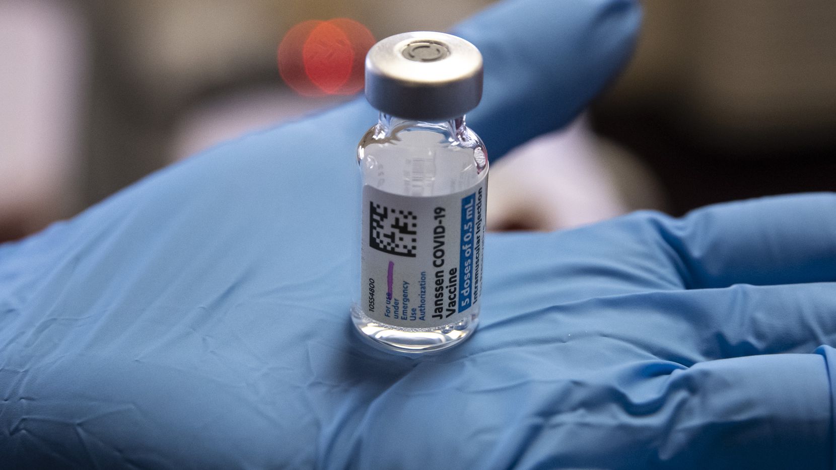 holds a vial of the Janssen COVID-19 vaccine at The Bentley retirement community located in Northwest Dallas