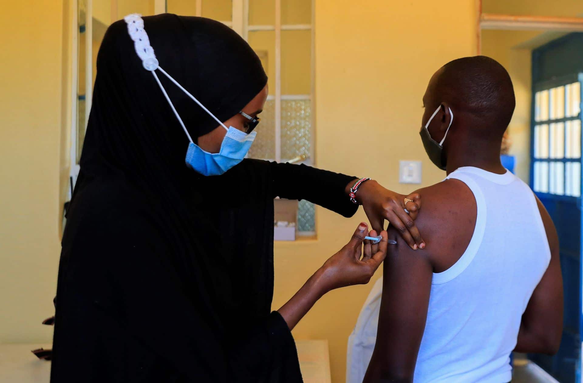 A nurse administers the coronavirus disease (COVID-19) vaccine to a man