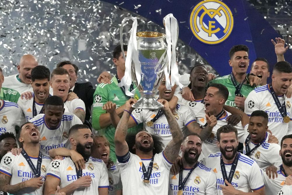 Real Madrid's Marcelo lifts the trophy as players celebrate winning the Champions League final soccer match between Liverpool and Real Madrid at the Stade de France