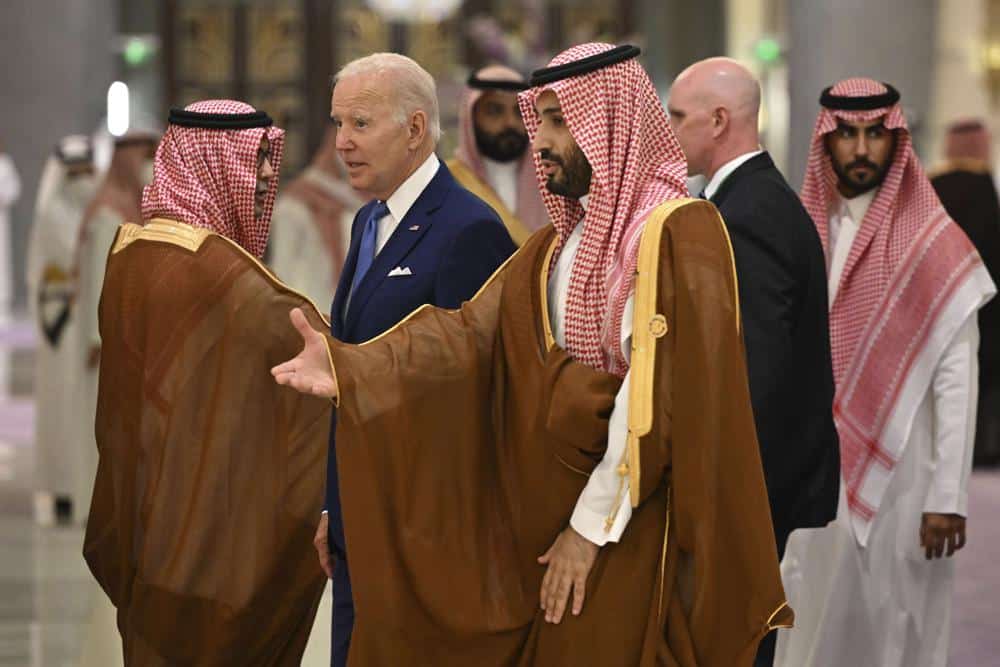 U.S. President Joe Biden, center left, and Saudi Crown Prince Mohammed bin Salman, center, arrive for the family photo during the "GCC+3" (Gulf Cooperation Council) meeting at a hotel in Saudi Arabia's Red Sea coastal city of Jeddah Saturday, July 16, 2022. (Mandel Ngan/Pool Photo via AP)
