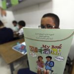 Schoolchild shows his English lessons book in a private school of Birkhadem