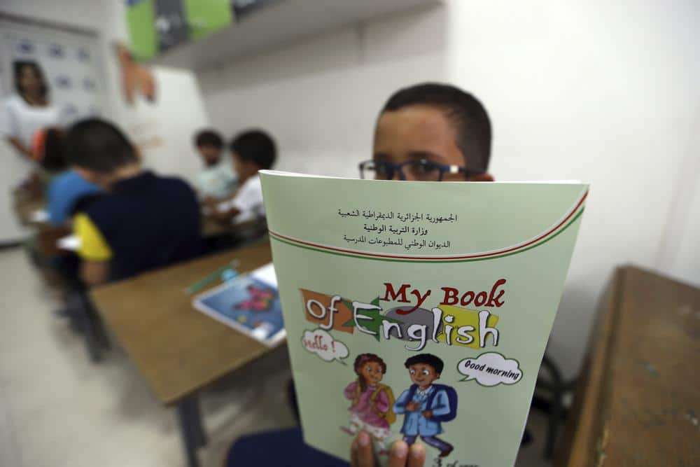 Schoolchild shows his English lessons book in a private school of Birkhadem
