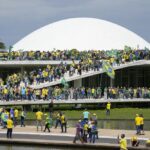 Protesters, supporters of Brazil's former President Jair Bolsonaro, storm the the National Congress building in Brasilia, Brazil, Sunday, Jan. 8, 2023. (AP Photo/Eraldo Peres)