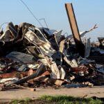 Debris covers a damaged building in Rolling Fork, Miss., Saturday, March 25, 2023. Powerful tornadoes tore through the Deep South Friday night, killing several people in Mississippi and obliterating dozens of buildings. (AP Photo/Rogelio Solis)