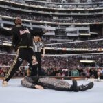 In this photo provided by WWE, rapper Snoop Dogg gets ready to drop The People's Elbow on Mike "The Miz" Mizanin during WrestleMania 39 on Sunday, April 2, 2023, at SoFi Stadium in Inglewood, Calif.