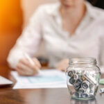 A jar with rolled banknotes on the table